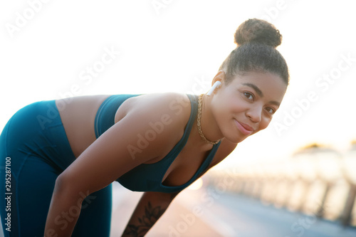 Woman smiling while enjoying her morning run © zinkevych