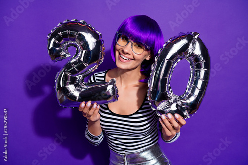 Photo of amazing lady hold hands ballons celebrate 20 year party wear specs striped pullover isolated purple background