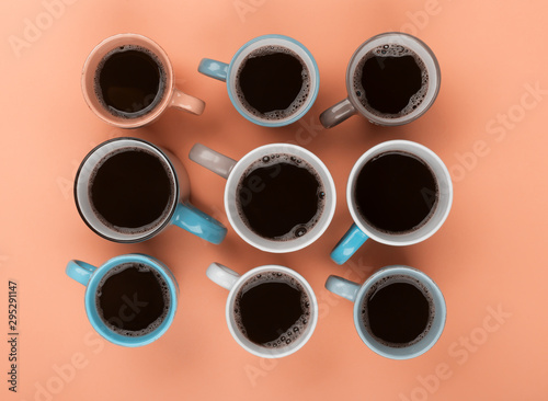 Coffee in the different cups on the beige background. Flatlay, cheerful day concept