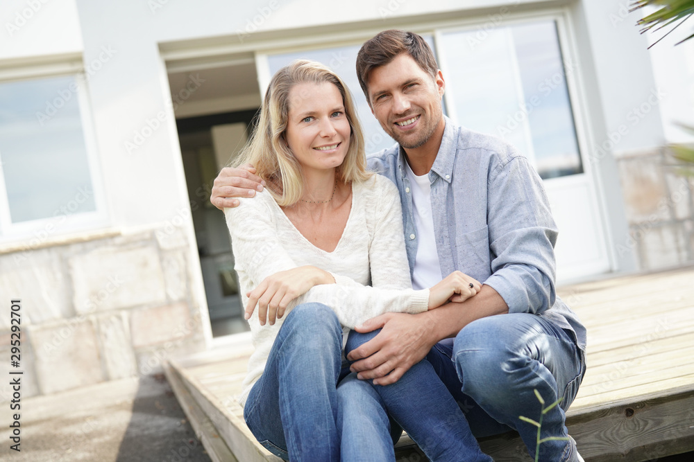 Obraz premium Cheerful couple in front of new house