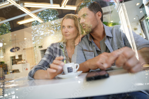 Middle-aged couple sitting at coffee shop