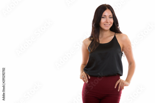 Studio shot of young happy businesswoman smiling while posing
