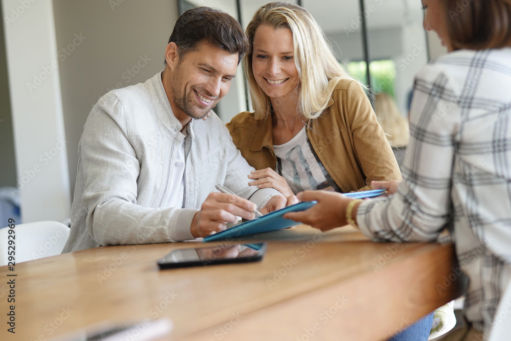 Couple signing  real-estate contract