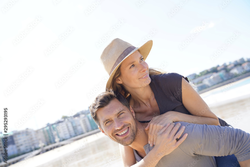 Fototapeta premium Middle-aged couple having fun at the beach