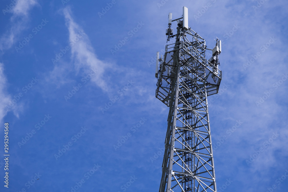 Telecommunication telephone signal transmission tower with beautiful blue sky and cloudy background