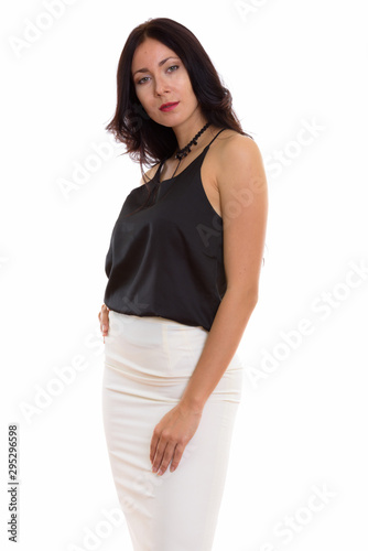 Studio shot of young beautiful businesswoman standing with hand
