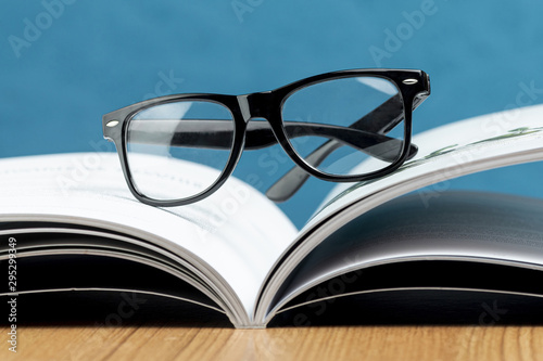 Close-up open book with glasses
