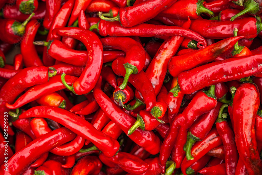 Red pepper. Bunch of ripe big red peppers at a street market. Background texture of red hot chili peppers seasoning a fiery dish for sale
