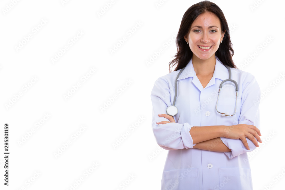 Studio shot of young happy woman doctor smiling with arms crosse Studio shot of young happy woman doctor smiling with arms crosse