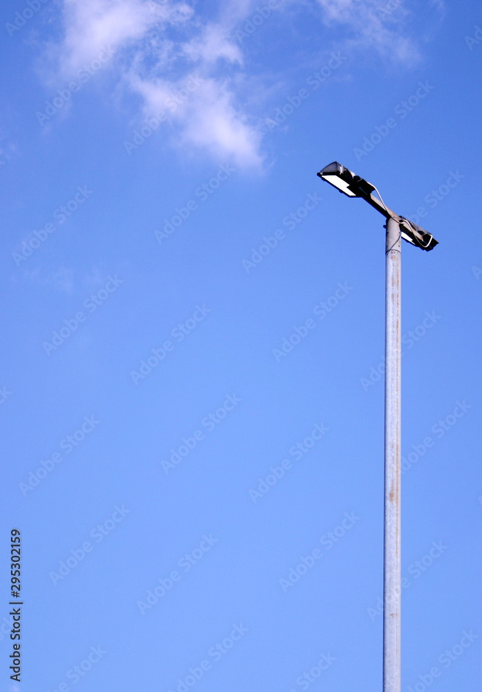 street lamp against a blue sky
