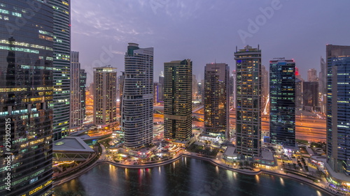Residential and office buildings in Jumeirah lake towers district day to night timelapse in Dubai