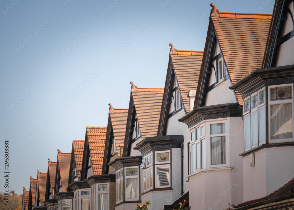 Fototapeta premium A row of typical British houses against blue sky