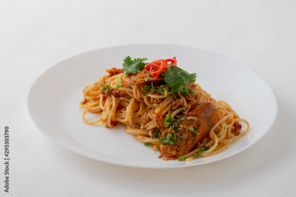 Spicy Spaghetti with Thai sausage on wood table. Spicy Spaghetti with Thai sausage on wood table.