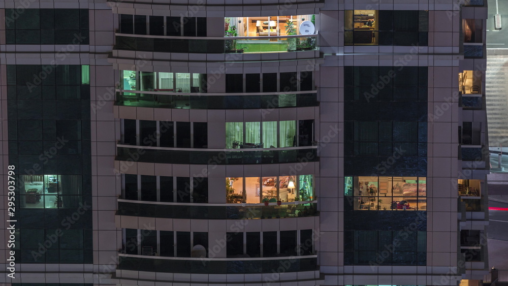 Obraz premium Night view of exterior apartment building timelapse. High rise skyscraper with blinking lights in windows