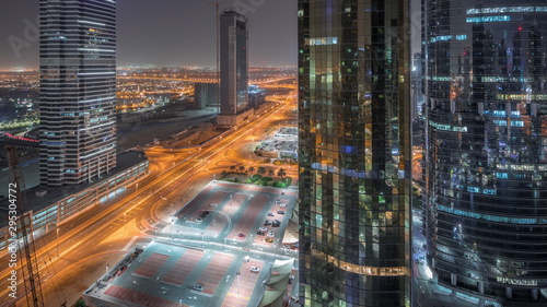 Office buildings in Jumeirah lake towers district night timelapse in Dubai