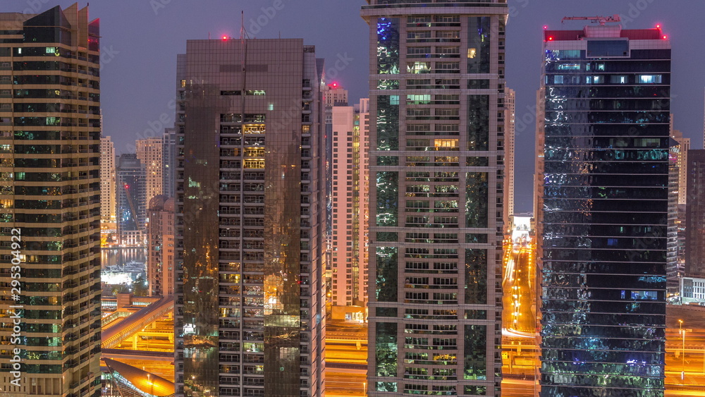 Residential and office buildings in Jumeirah lake towers district night to day timelapse in Dubai