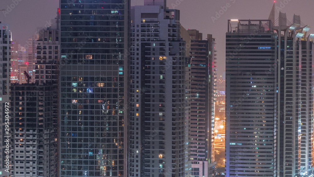 Residential and office buildings in Jumeirah lake towers district night to day timelapse in Dubai Residential and office buildings in Jumeirah lake towers district night to day timelapse in Dubai