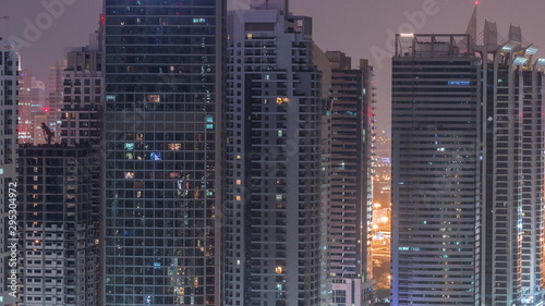 Residential and office buildings in Jumeirah lake towers district night to day timelapse in Dubai