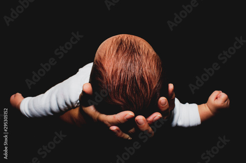 Newborn baby boy in his mother's hands photo