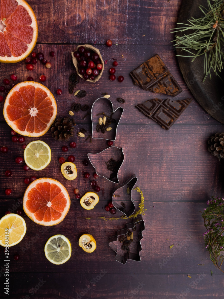 Food background with christmas spices, dried apples, nuts, citrus fruits, cydonia, cranberries, raisin, and baking dish on wooden background.Top view with copy space Food background with christmas spices, dried apples, nuts, citrus fruits, cydonia, cranberries, raisin, and baking dish on wooden background.Top view with copy space