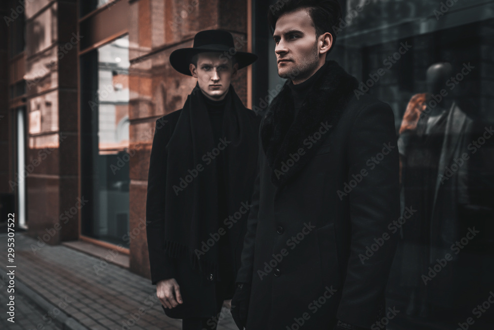 Stylish young men walking on city street. Wearing in casual and classic clothes. Trendy bearded models portrait. Urban lifestyle Stylish young men walking on city street. Wearing in casual and classic clothes. Trendy bearded models portrait. Urban lifestyle