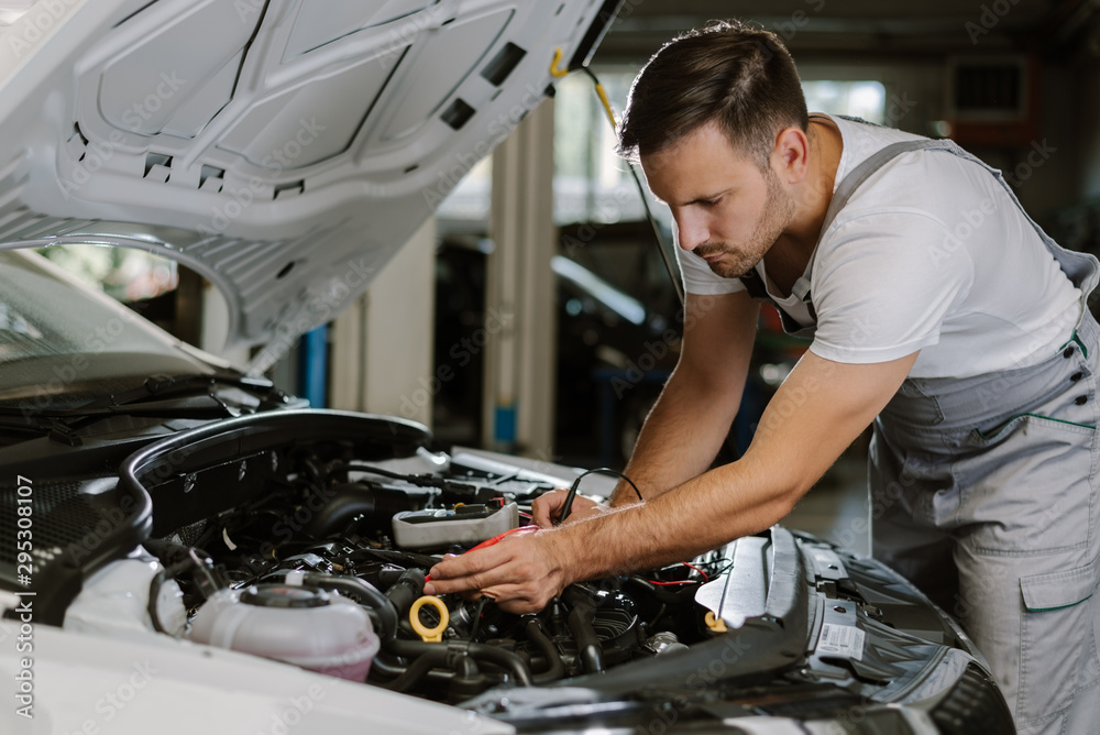 Auto mechanic working on car diagnostic in a repair shop Auto mechanic working on car diagnostic in a repair shop