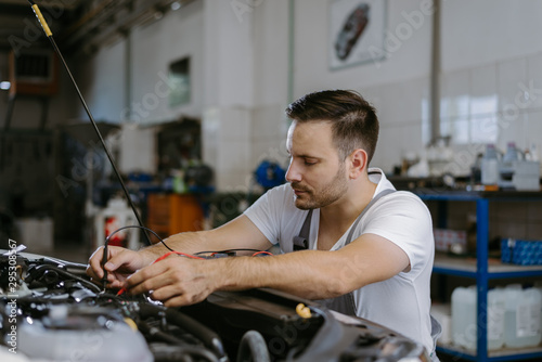 Mechanic working with car diagnostic tool in a workshop