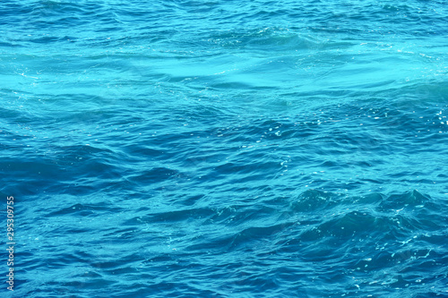 clear waving transparent blue sea water background.