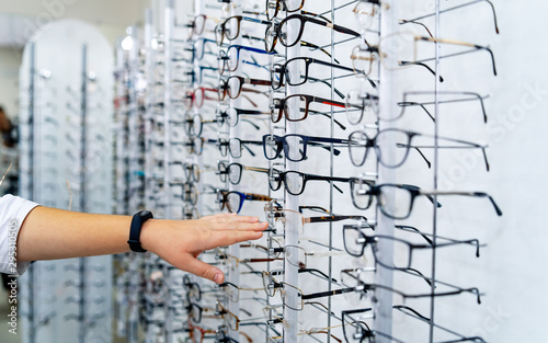 Row of glasses at an opticians. Eyeglasses shop. Stand with spectacles. © Vadim