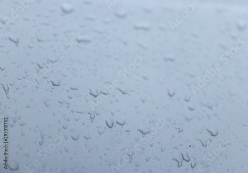 Pictures of water droplets caused by rain, attached to the car glass and various parts of the car.