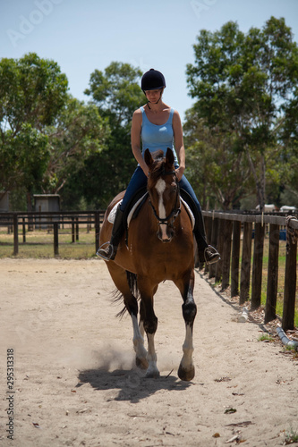young girl riding a horse © PerthCreativeStudios