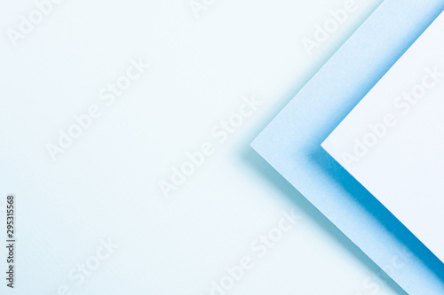 Blue toned set of triangular paper sheets with copy space