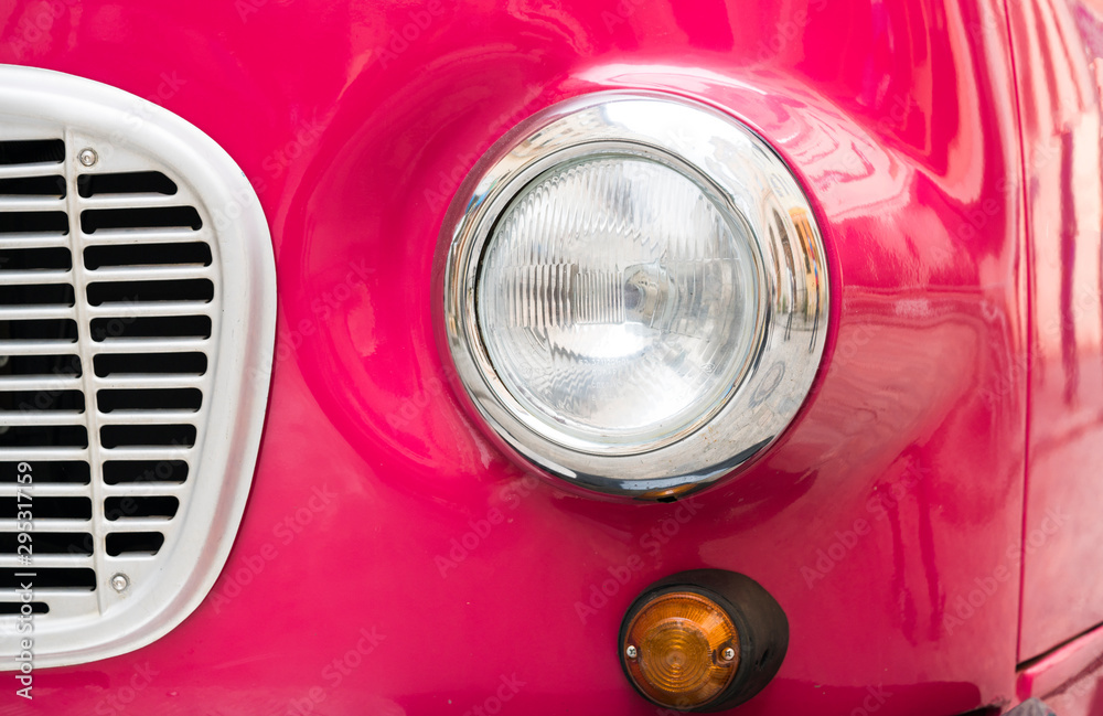 Retro pink car close up. Beautiful retro pink car close up on city background close up