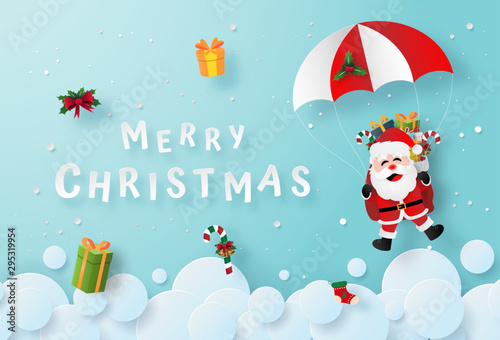 Origami paper art of Santa Claus make a parachute jump on the sky, Merry Christmas and Happy New Year