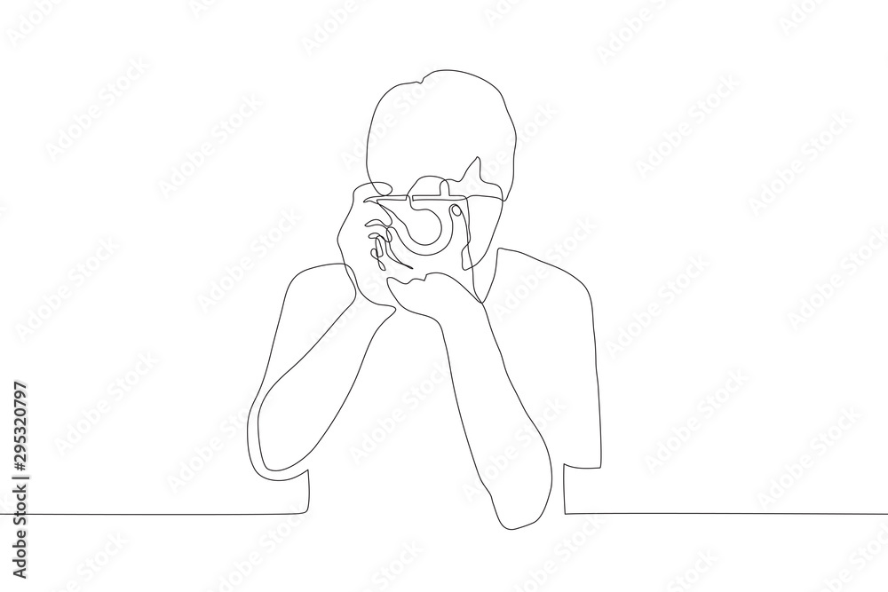 one continuous line art of a male holding and looking at the camera aimed at the viewer. Professional photographer takes photos. It can be used for animation. Vector one continuous line art of a male holding and looking at the camera aimed at the viewer. Professional photographer takes photos. It can be used for animation. Vector
