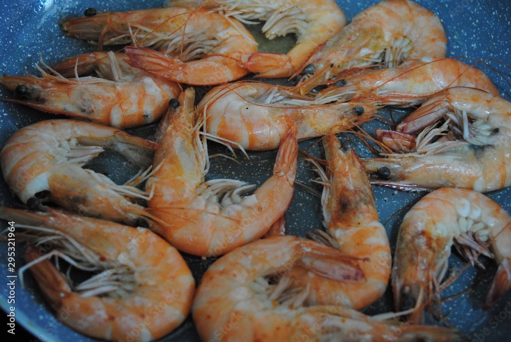 Cooking fresh seafood. Shrimp, stingray, dorado and seabass on a plate.