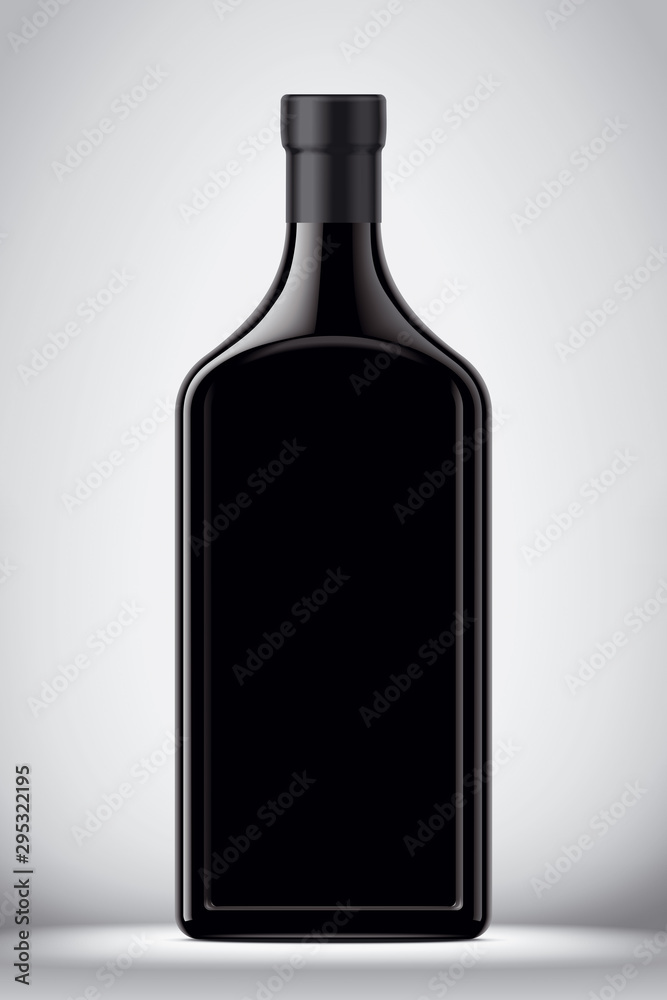 Glass black bottle on gray background Glass black bottle on gray background