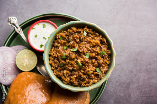 Kheema / keema Pav or Khima Paav is a spicy curry dish made up of minced chicken or lamb cooked with onion, tomatoes, served with buns. selective focus photo