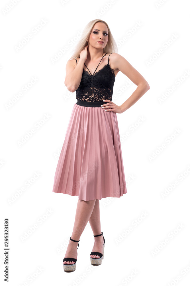 Cocky confident young blonde woman in stylish elegant fashion posing and looking at camera with attitude. Full body isolated on white background. 