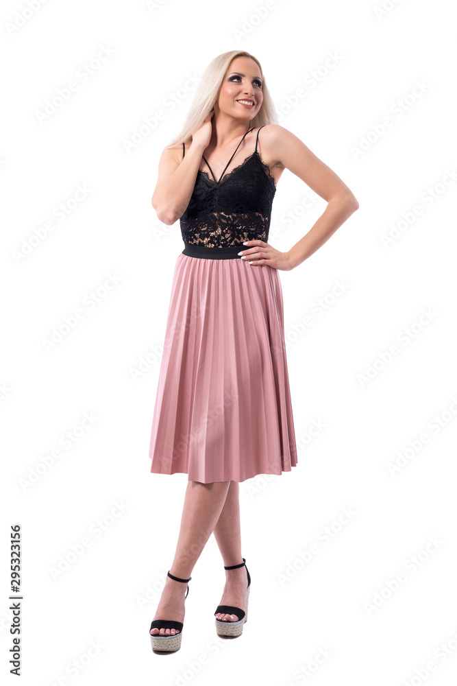 Gorgeous smiling young blonde woman in elegant classy fashion posing and looking up. Full body isolated on white background. Gorgeous smiling young blonde woman in elegant classy fashion posing and looking up. Full body isolated on white background.