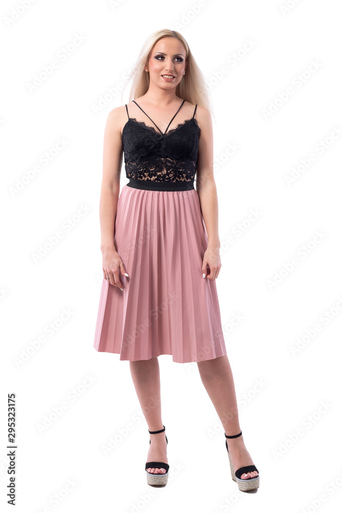 Confused blonde hair woman in elegant clothes looking away with arms down. Full body isolated on white background. 