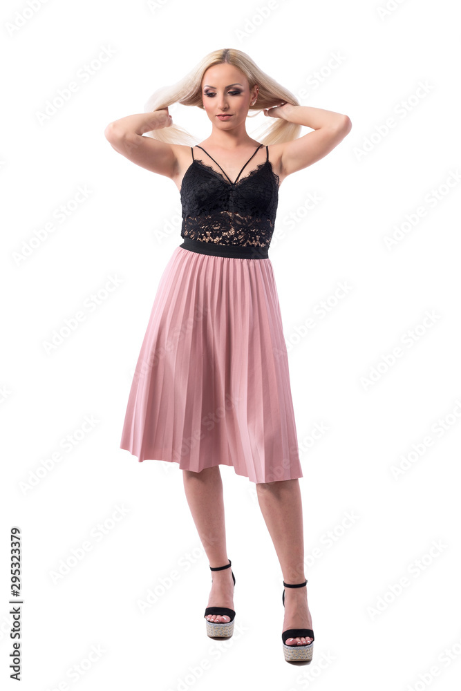 Young well dressed blond hair woman in elegant fashion tossing hair getting ready. Full body isolated on white background. 