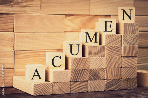 the word of acumen is made with building blocks on a wooden background, vignetting and toning the image, selective focusing