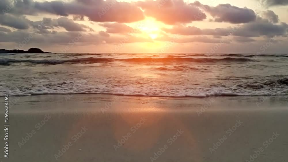 Scenic view on waves of sunset sea beach and tropical island. Golden sunshine and relaxation. Travel and vacations concept. Scenic view on waves of sunset sea beach and tropical island. Golden sunshine and relaxation. Travel and vacations concept.