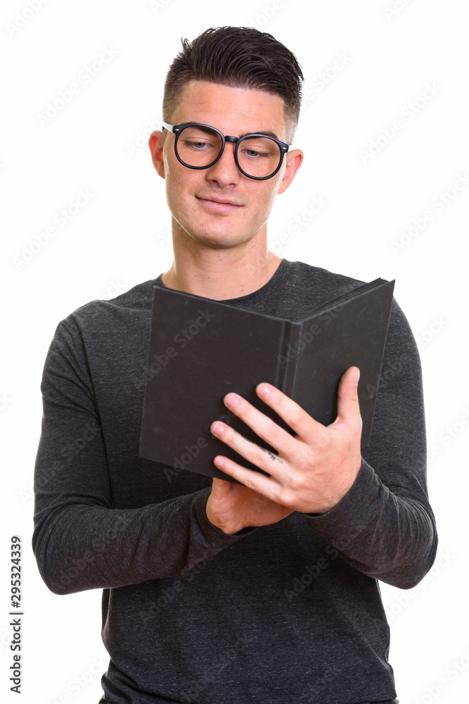 Studio shot of young handsome man reading book Studio shot of young handsome man reading book