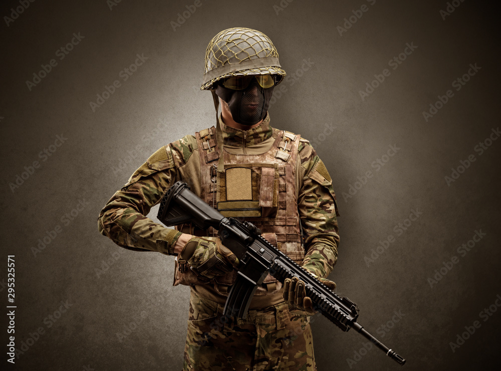 Soldier agent in a dark room with arms on his hand and gas mask