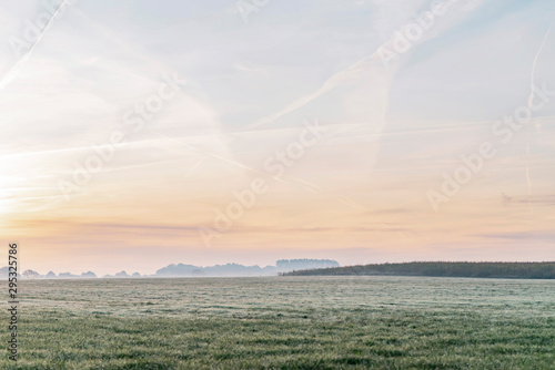 Misty rural landscape at sunrise.