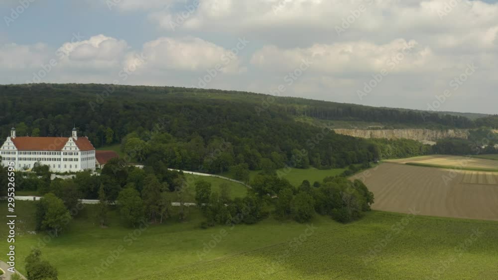 Aerial view of the palace Schloss Mochental in Germany on a sunny day in summer. Descending beside the palace. Aerial view of the palace Schloss Mochental in Germany on a sunny day in summer. Descending beside the palace.