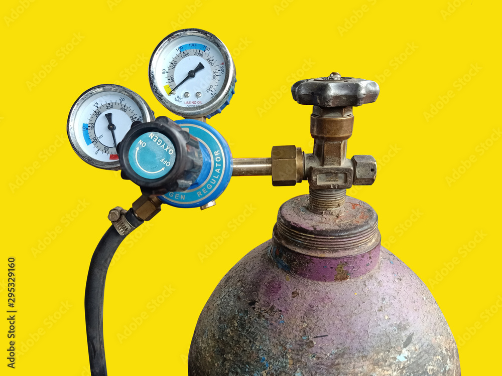 the oxygen tank with pressure gauge and rubber line on yellow background isolated clipping the oxygen tank with pressure gauge and rubber line on yellow background isolated clipping