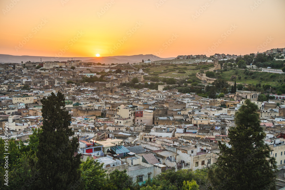 Panoramic scenic view over the roof tops of Medina Fes city at sunrise in Morocco